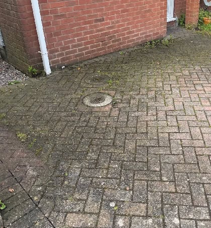 Dirty moss covered driveway needing pressure washing in Hednesford WS12