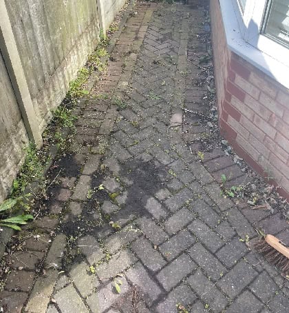 Dirty patio slabs needing pressure washing in Heath Hayes WS12