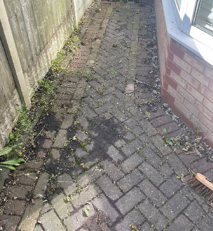 Dirty patio slabs needing pressure washing in Wimblebury WS12