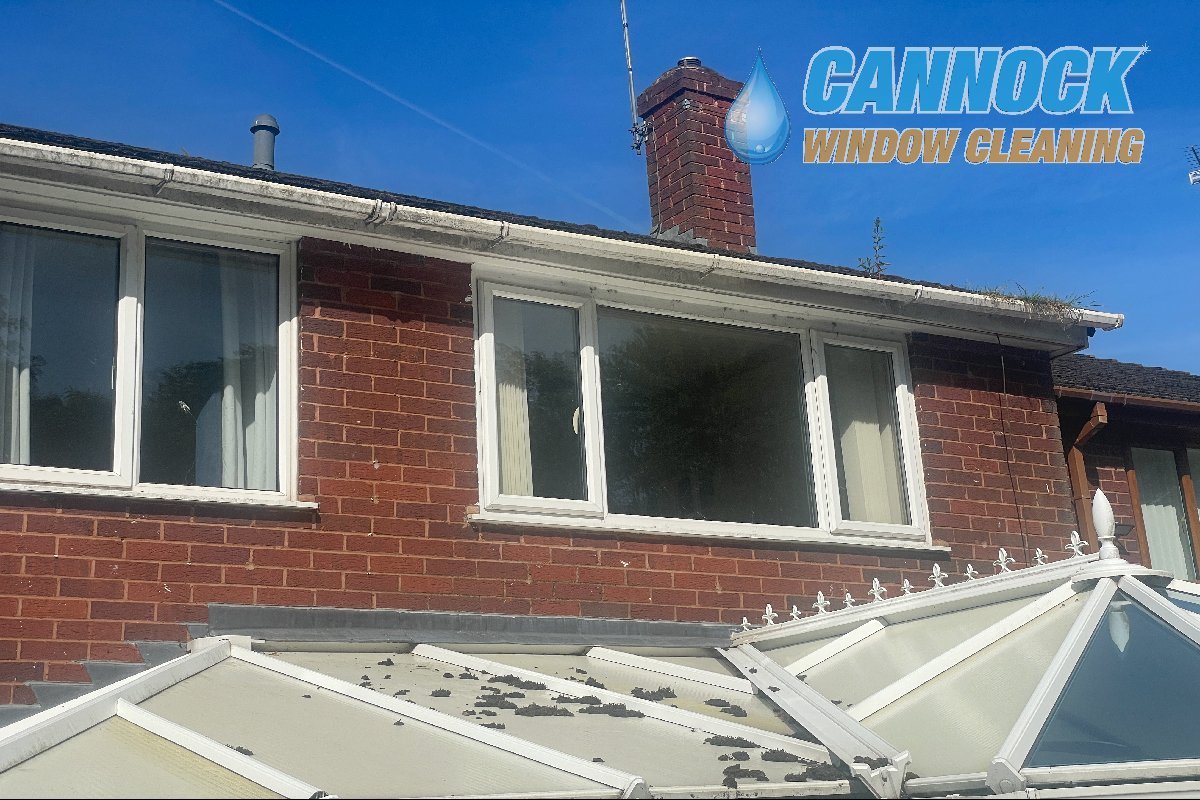 Blocked gutters above a conservatory roof before clearing Cannock