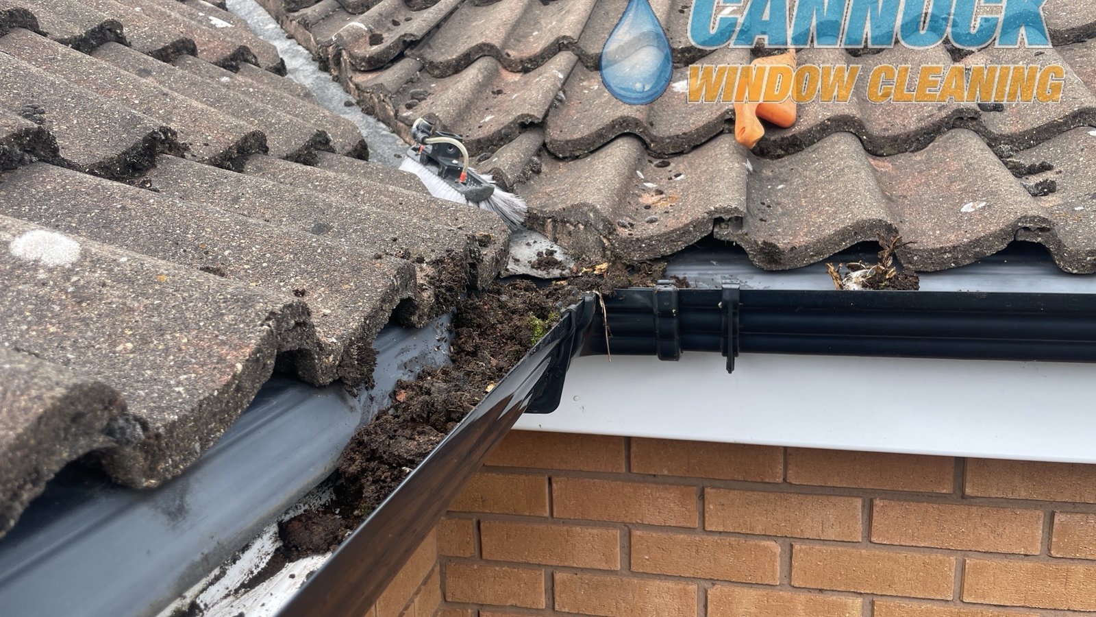 Gutter clearing in Cannock, before: gutter blocked with debris
