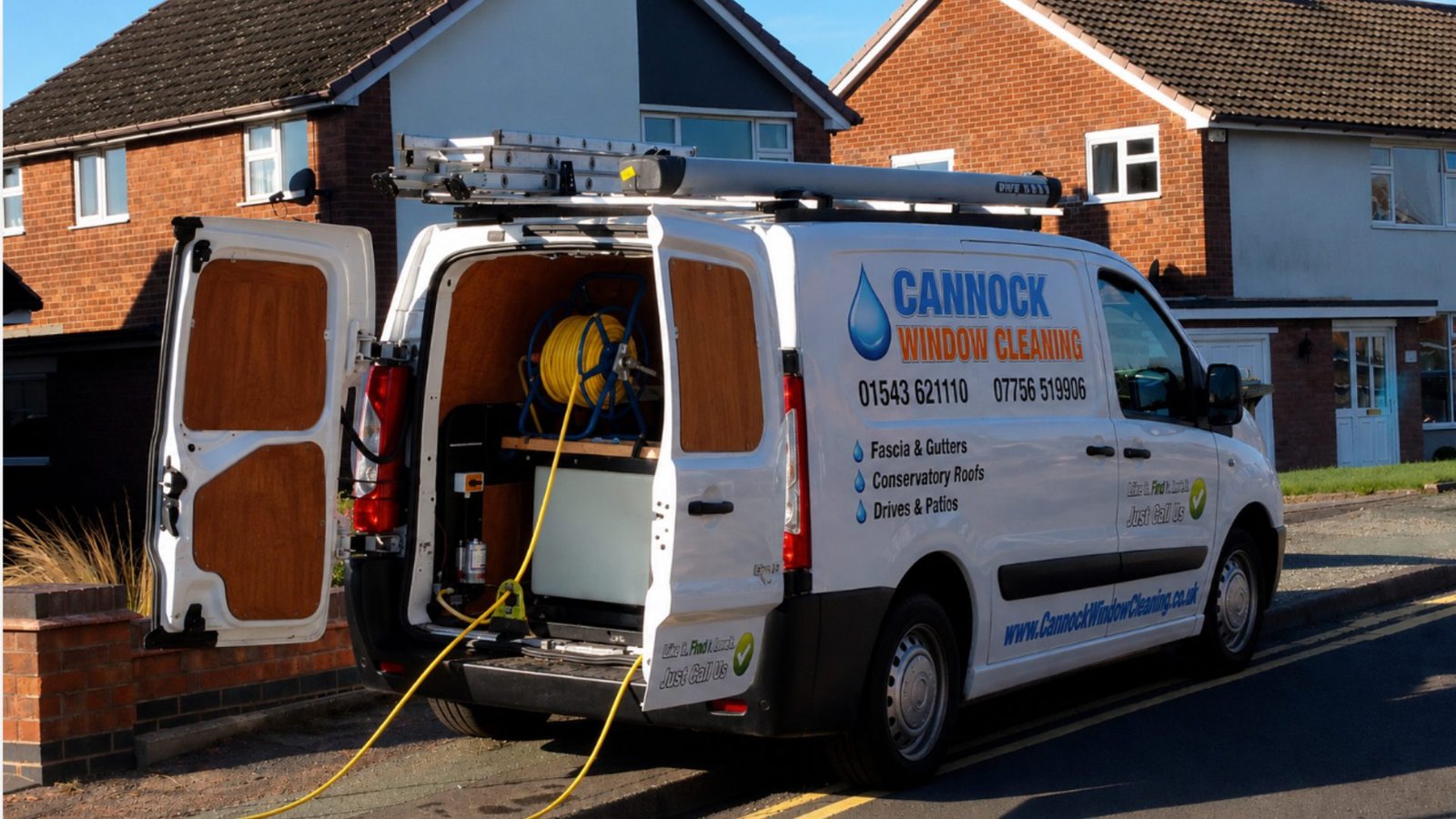 Cannock Window Cleaning van on a residential street in Cannock, rear doors open showing the water-fed hose reel, ladder on the roof rack