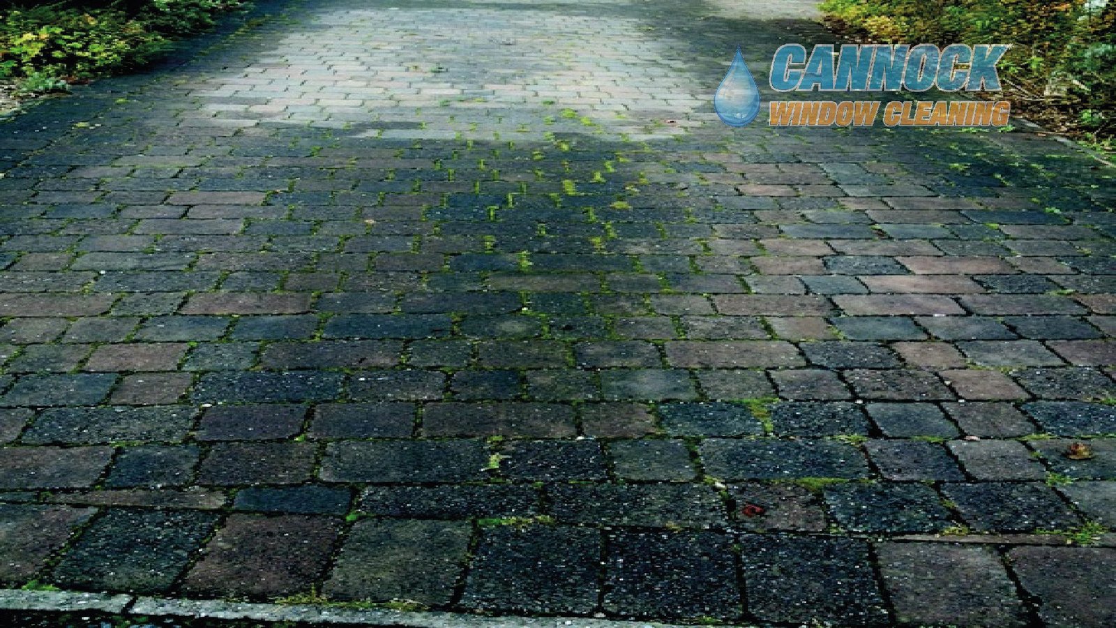 Block paving thick with moss and weeds before cleaning