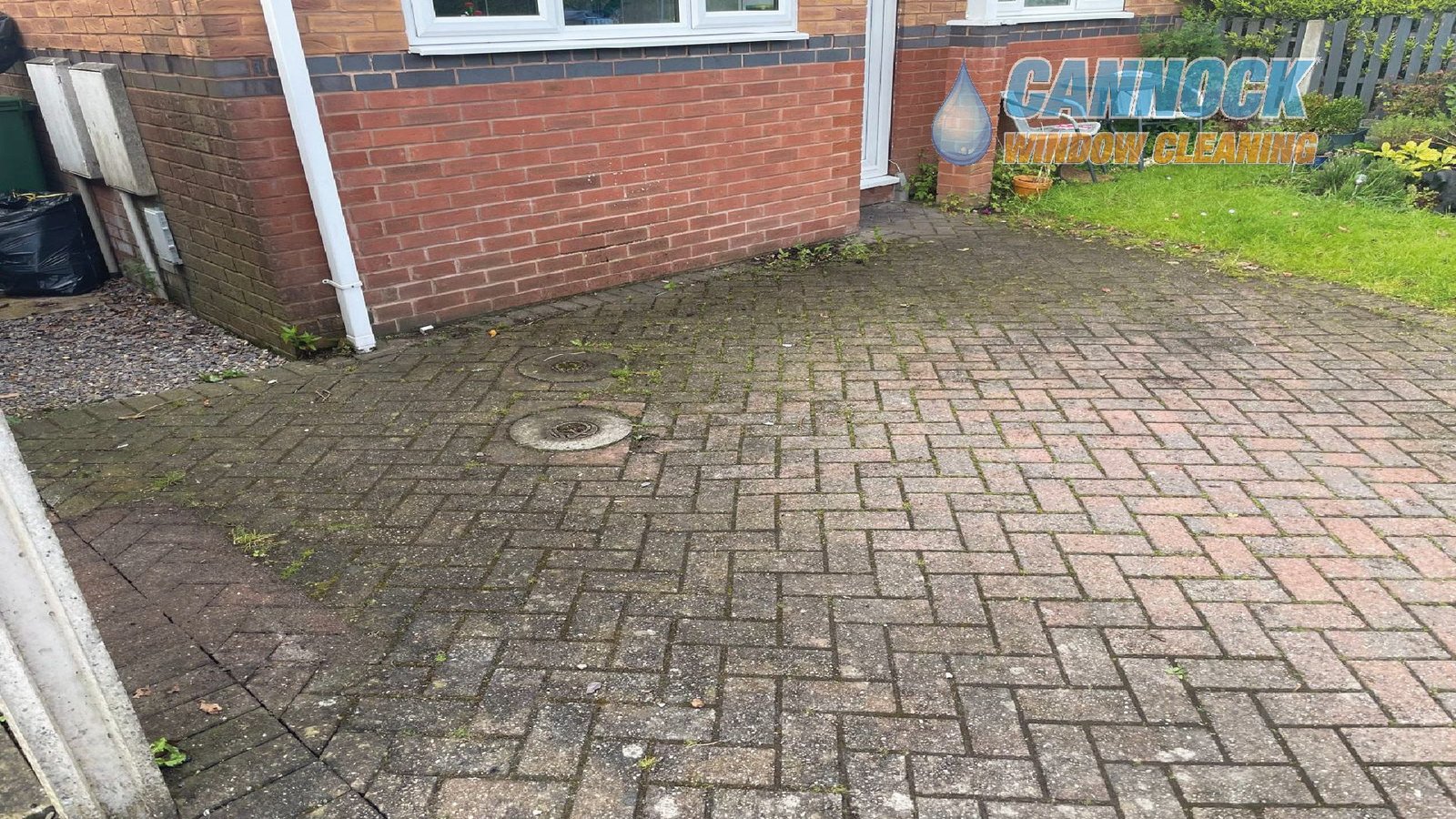 Block paving drive green with moss beside the house before cleaning