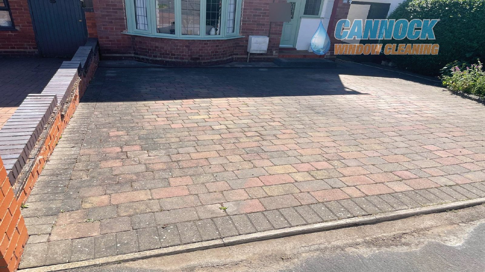 Multi-coloured block paving drive faded and grey before cleaning