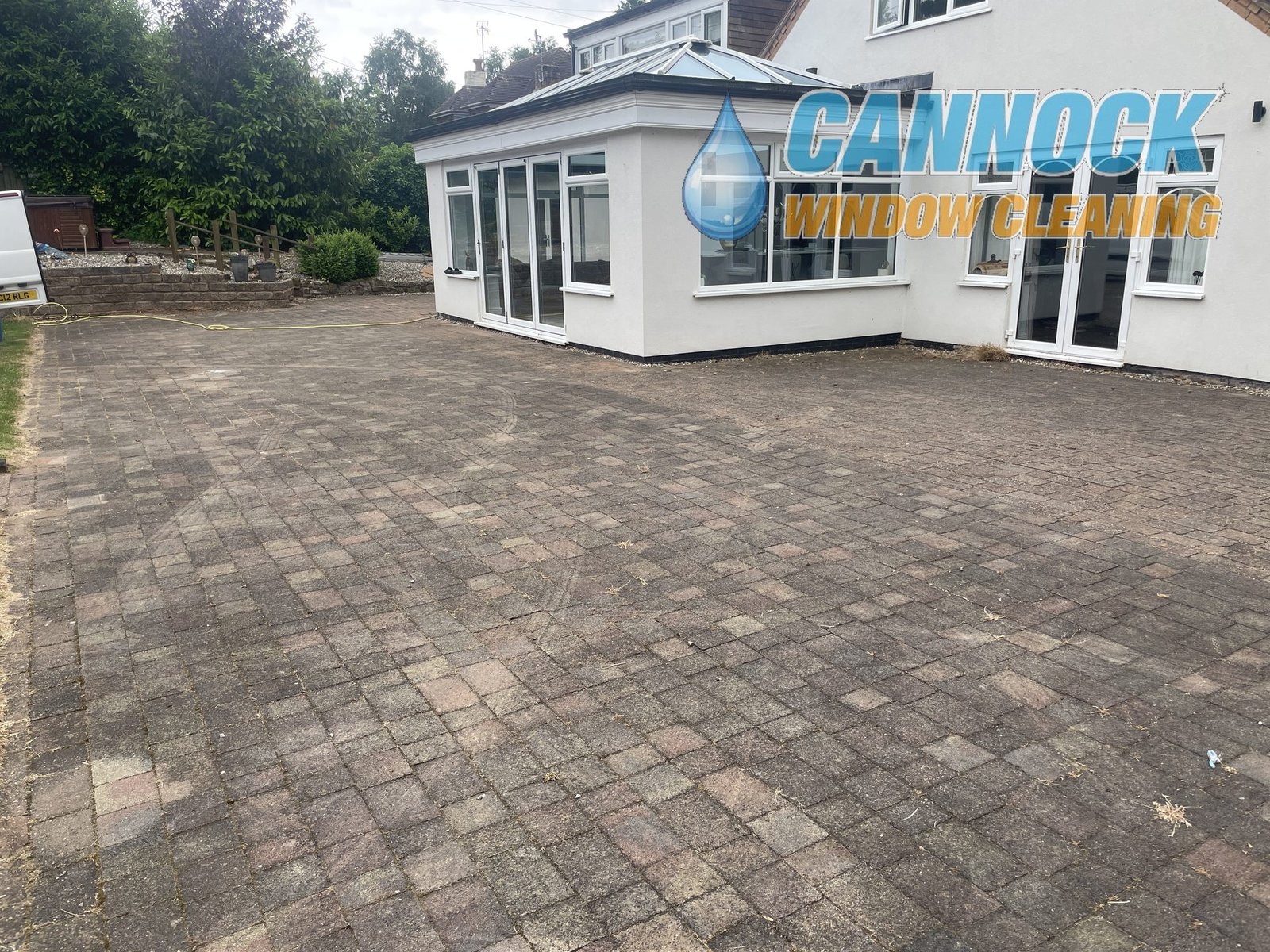 Large block paving patio grey and dull before cleaning