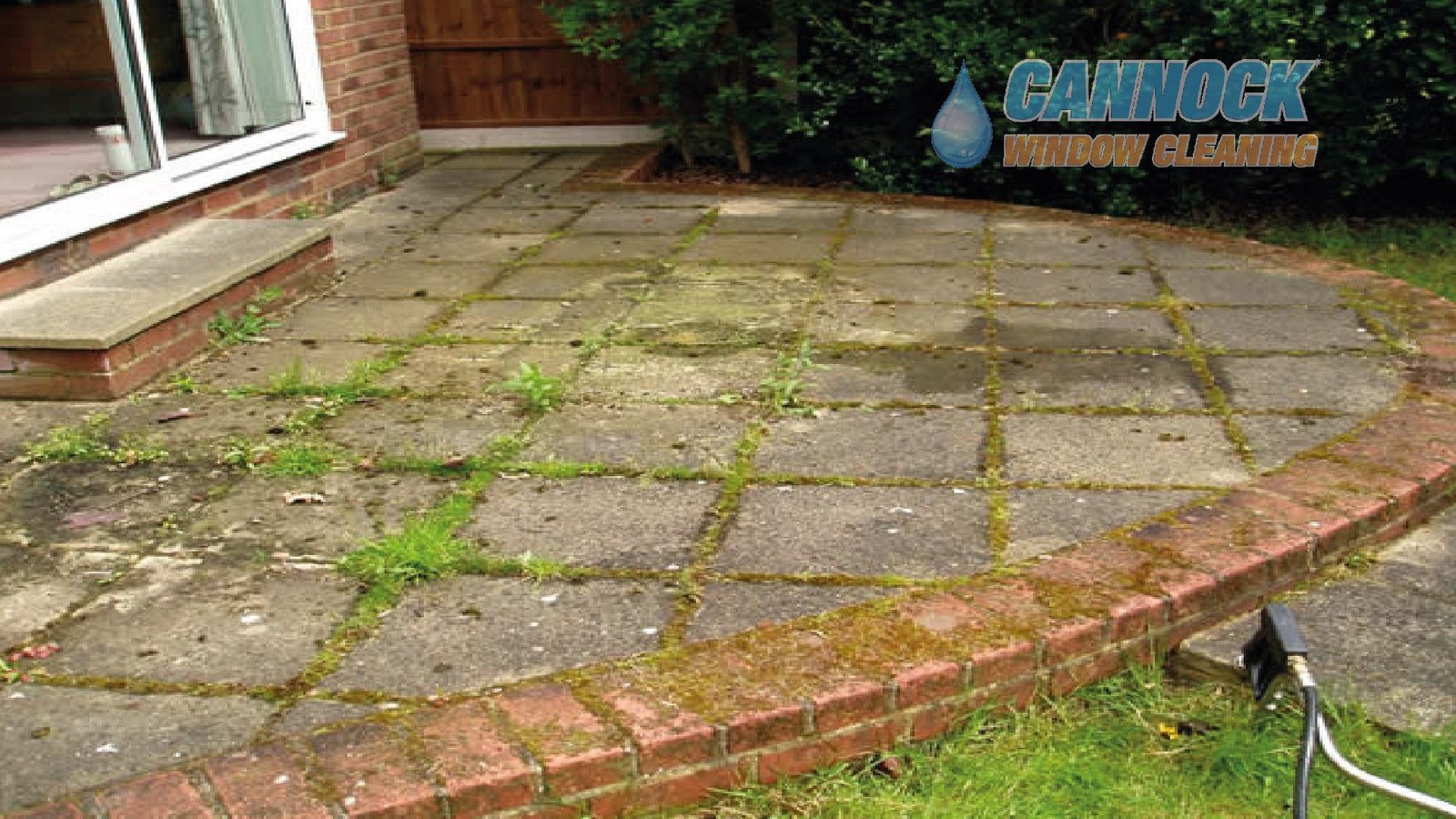 Curved slab patio with moss and weeds in the joints before cleaning