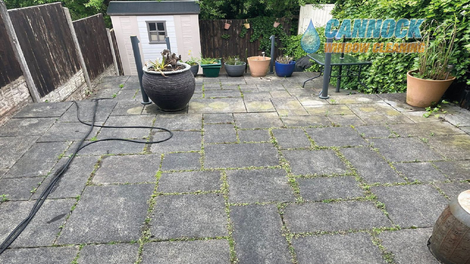 Slab patio covered in lichen and moss before cleaning