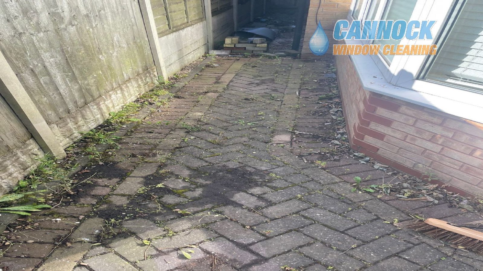 Herringbone side path covered in moss and weeds before cleaning