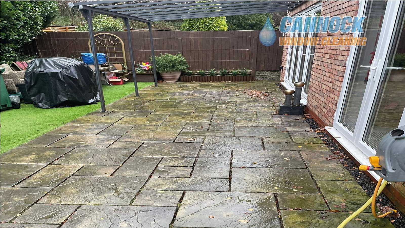 Slab patio under a pergola green and wet before cleaning