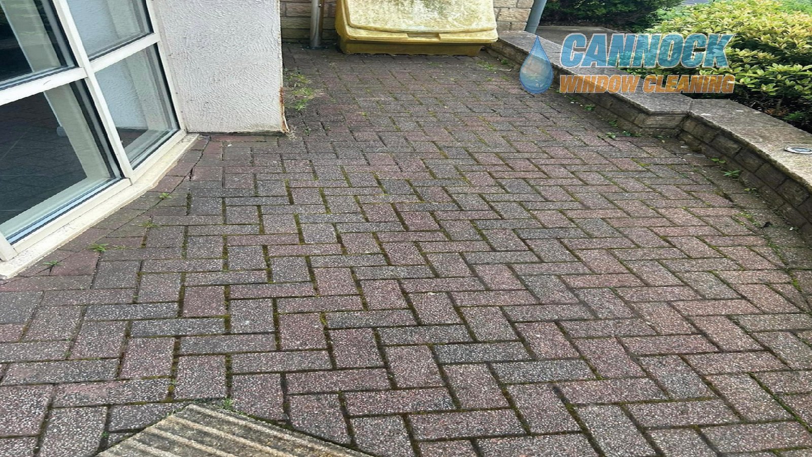 Herringbone block paving patio dull and green before cleaning